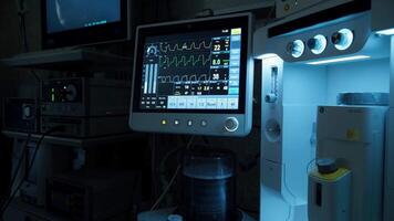 Advanced life support equipment displays patient's vital signs, creating a tense atmosphere in a dimly lit operating room, highlighting the importance of technology in critical care video