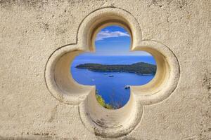 Island near Dubrovnik through stone window view photo