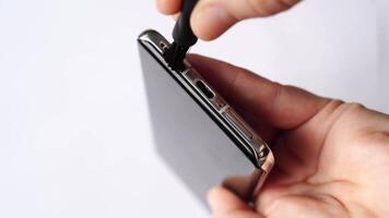 Closeup sequence of hands connecting usb cable to smartphone on white background for technology concepts. video