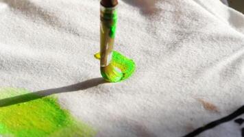 Artistic transformation. painting bright green abstract patterns on white canvas. video