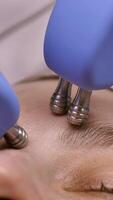 Microcurrents for lifting oval of face without injections. beautician uses microstring massager to relieve muscle fatigue, stimulate the production of elastane collagen and improve skin turgor video