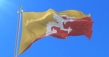 Bhutan flag waving at wind in slow with blue sky loop video