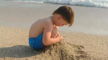Summertime season. Little Child Building Sand Castle Sitting On Beach video
