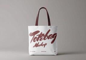 Tote bag mockup with red handles on light background front view photo
