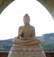 sitting buddha stone sculpture in temple of thailand photo