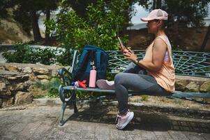 Woman Relaxing on a Park Bench During Her Fitness Routine photo