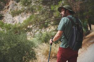 Man Hiking Through Forest Path Carrying Backpack, Exploring Nature photo