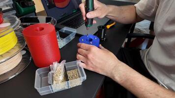 Caucasian male in 30s using 3D printer for crafting, showcasing DIY culture, innovation, and technology trends video