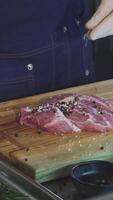 Chef skillfully seasoning fresh pork meat with a blend of spices for a delectable steak video