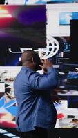 Vertical Tech savvy individual discuss about digital content on phone call, using cloud based applications and social media icons to reflect global connection, trends and AI driven influence. Camera A. video