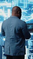 Vertical Tech savvy black engineer working with AI brain data visualization, illustrating computer science and automation tools for deep learning. Implementing neural networks systems. Camera A. video