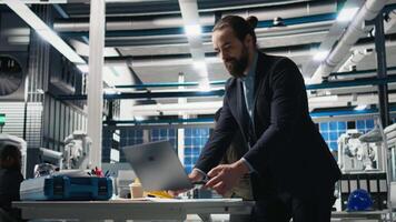 Supervisor analyst assesses solar panels production line in factory, representing technical precision and corporate strategy in the future of green energy. Supervises manufacturing. Camera B. video