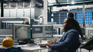 Industrial operations expert checking performance data in a solar panel factory, showcasing dedication to workplace efficiency and working on green energy manufacturing and engineering. Camera B. video