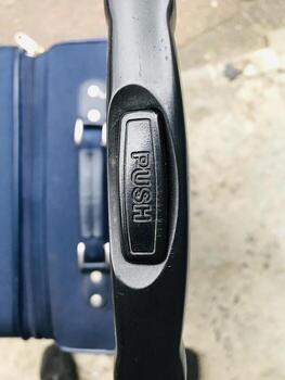 Travel suitcase with push handle for easy mobility in transit, photo