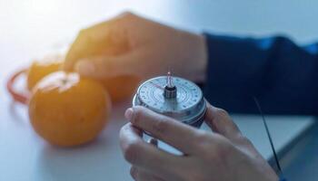 A person holding a measuring device over an orange photo
