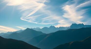 A mountain range with clouds and sun photo