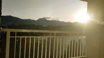 The sun is setting over mountains in the background photo