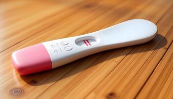 A close-up shot of a positive pregnancy test on a wooden surface. photo