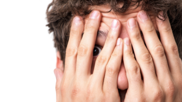 Young man hiding face showing anxiety and fear with transparent background png