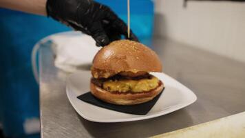 Chef Putting The Wooden Stick Inside The Burger Ready To Be Served video