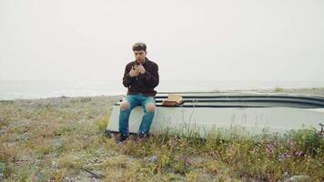 Man Sit On A Boat On The Beach During Winter And Doing A Prayer video