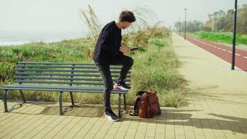 Man Picking Up Notes From The Backpack And Starting To Study On The Park Bench video