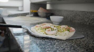 Chef Using The Peel To Put The Pizza In The Oven video