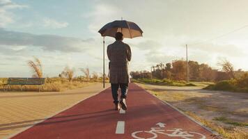 Man Walks with an Umbrella on a Sunny Day video