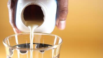 Pouring chocolate milk into a glass video