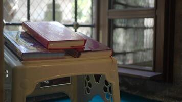 Quran resting on a stool near a window in a mosque video