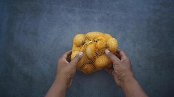 Hands handling a bag of fresh potatoes in the kitchen video