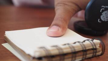 finger on fingerprint scanner over notepad video