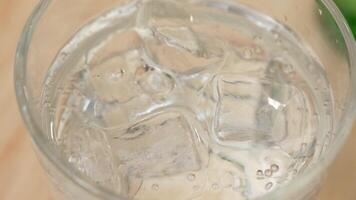 Fresh water with ice cubes in clear glass video