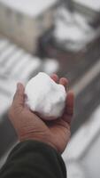 Snowball creation during winter in an urban setting video