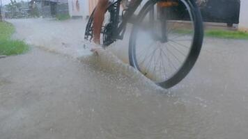 Close-Up of Bicycle Wheel Making a Splash in Puddle. Slow Motion video