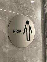 Modern Bathroom Indicator for Gentlemen, Featuring a Minimalist Design and Indonesian Translation photo