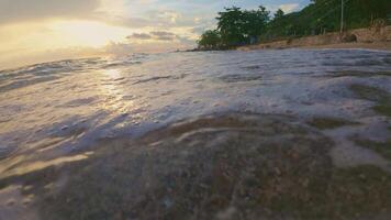 Slow Motion of Waves Lapping on Sandy Beach at Sunset video