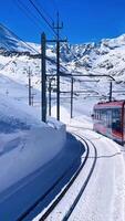 Stunning mountain views from Zermatt with the iconic Matterhorn rising above the clouds. A tranquil train journey experience that captures the spirit of adventure. video