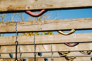 Close up of Various Holds, Chains, and Ropes on a Climbing Structure. photo