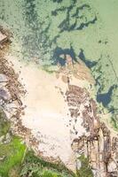 drone shot of a pristine coastline with clear turquoise water Drone zenithal view, summer background concept photo