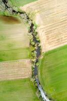 aerial top down view of agricultural fields and a winding river photo