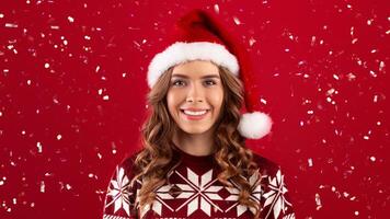 Portrait of beautiful smiling girl in Santa hat and Christmas sweater over red background, panorama photo