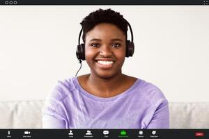 Headshot portrait screen view of smiling young black woman making call with friend or relatives, happy millennial female having virtual meeting online using webcam conference on computer photo