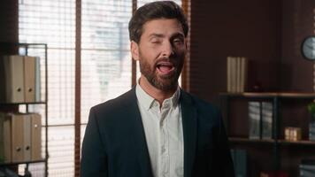 Smiling positive business man blinking eye Caucasian middle-aged businessman male worker blink in office looking at camera happy good job success entrepreneur manager 40s formal employer portrait video