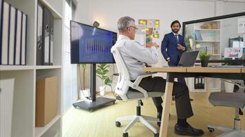 In a contemporary office, two senior executives with a mission to brainstorm and monitor the progress of a business project,1 video