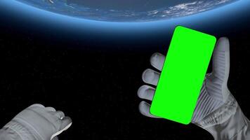 3d rendering. Astronaut in outer space holds a smartphone with green screen, ideal for advertising, branding, or promotional content in sci-fi, or futuristic campaigns. video