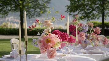 An Elegant and Charming Outdoor Dining Setup Enhanced with Beautiful Floral Arrangements. Action video