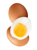 Raw chicken eggs and cooked or boiled chicken egg with egg yolk in half in small pile isolated with clipping path in file format png