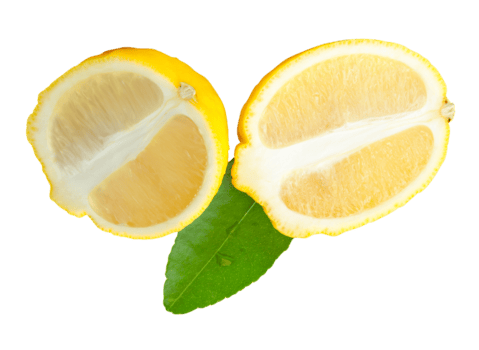Ripe sour lemon fruit or slices in two ellipse or oval halves with green leaf isolated with clipping path in file format png