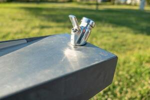 detail of a water spout in a public space modern public water fountain in a park photo